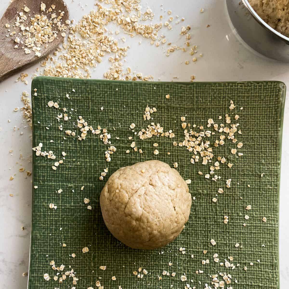 oat fufu placed on a green square dish garnished with oats